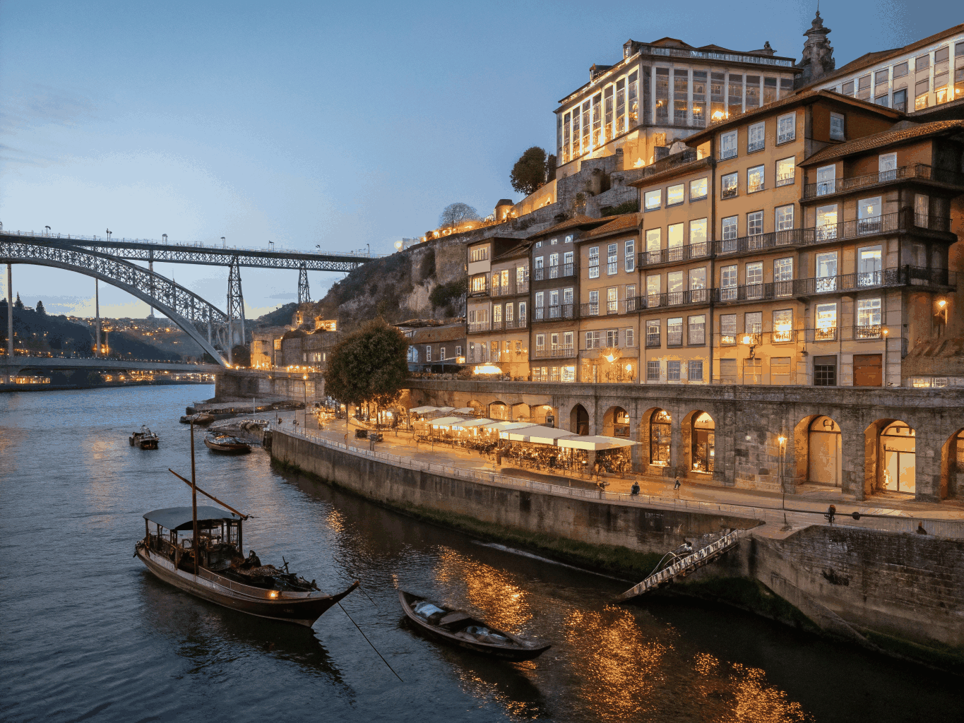 Historic Porto riverside and Dom Luis I bridge at dusk
